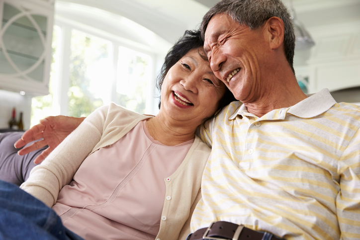 Senior Asian Couple At Home Relaxing On Sofa Together Couples Therapy